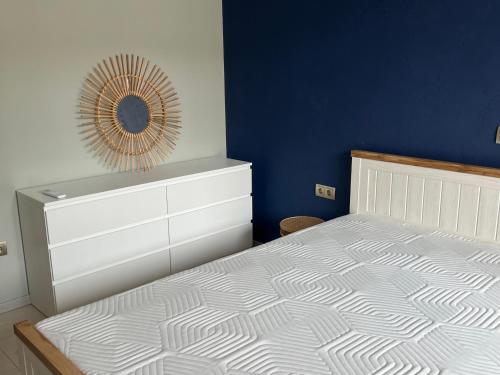 a bedroom with a bed with a dresser and a mirror at Apartment N 1 in Chernomorets