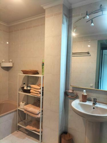a bathroom with a sink and a mirror and a shower at Salinas en el horizonte in Salinas