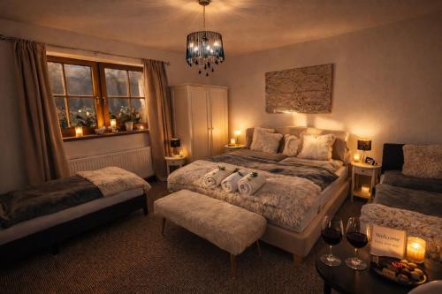 a bedroom with two beds and a chandelier at Rioba Chalet in Nová Bystrica