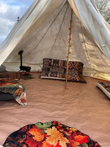 a tent with pillows on the floor of it at Happy Meadows - The Chick Inn in Long Stratton