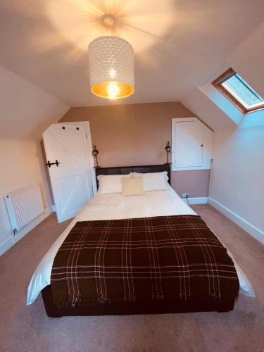 a bedroom with a large bed in a attic at Brylach Steading in Aberlour