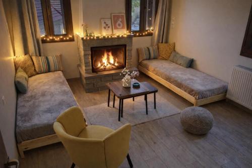 a living room with a couch and a fireplace at Metsovo Fireplace Retreat I in Metsovo