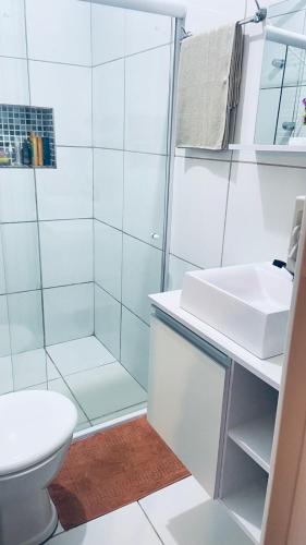 a bathroom with a shower and a toilet and a sink at Casa familiar perto da Escola São Cristovão in Garanhuns