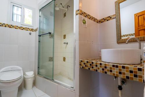 a bathroom with a sink and a shower at Kevin Kondos in Bocas Town