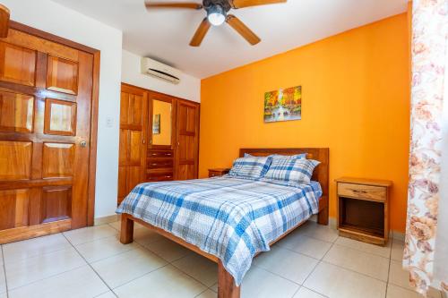 a bedroom with a bed and a ceiling fan at Kevin Kondos in Bocas Town