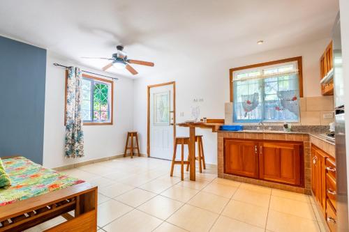 a kitchen with a ceiling fan and a table at Kevin Kondos in Bocas Town