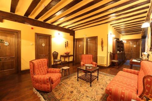 a living room with a couch and chairs and a table at Posada Palacio de Beola by Clabao in Almándoz