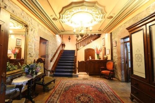 a hallway with a staircase in a building at Posada Palacio de Beola by Clabao in Almándoz