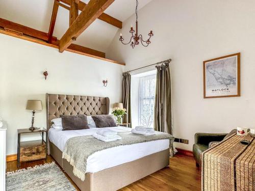 a bedroom with a large bed and a window at 3 Bed in Matlock oc-86482 in Cuckney