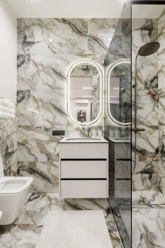 a bathroom with a toilet and a sink and mirrors at Renest Chicago Vinyl Lounge in Chişinău