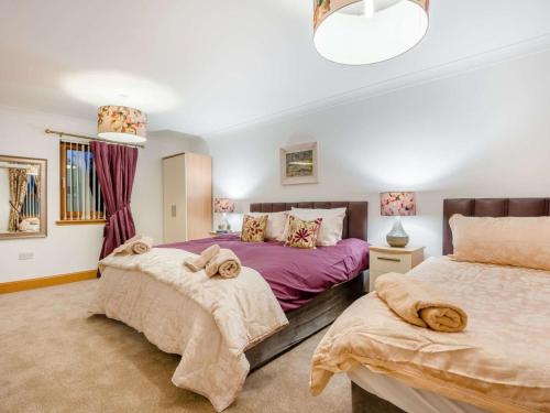 a bedroom with two beds with towels on them at 3 Bed in Bathgate oc-90491 in Fauldhouse