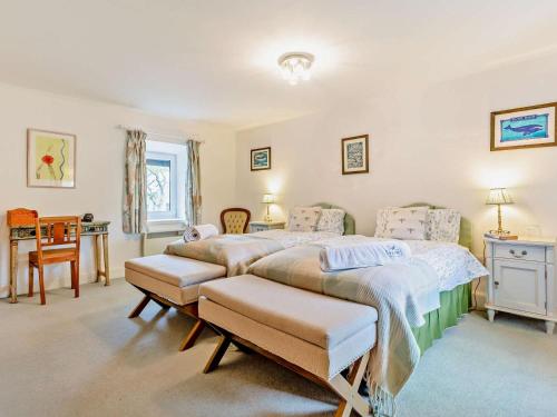 a bedroom with two beds and a table at 3 Bed in Inverness oc-ca134 in Farr