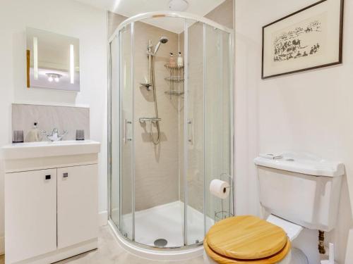 a bathroom with a shower with a toilet and a sink at 3 Bed in Inverness oc-ca134 in Farr