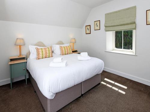 a bedroom with a large white bed with a window at 2 Bed in Lockerbie oc-94304 in Brydekirk