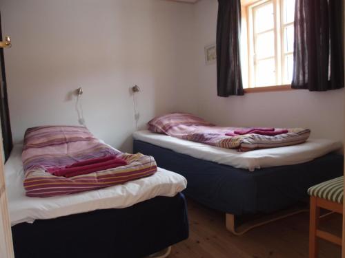 Bjældskovgaard Holiday House tesisinde bir odada yatak veya yataklar