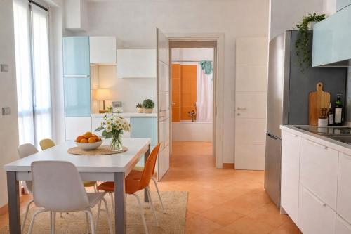 a kitchen and dining room with a table and chairs at Adamo ed Eva Resort in Numana