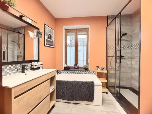 a bathroom with a bed and a glass shower at Suite Home in Crespin