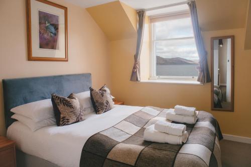 a bedroom with a bed with towels on it at Inn at Ardgour in Onich