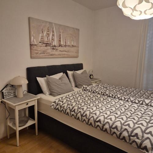 a bedroom with a bed and a table with a lamp at Roko Apartments in Biograd na Moru