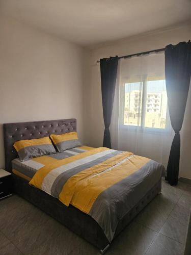 a large bed in a bedroom with a window at Mimi in Dakar