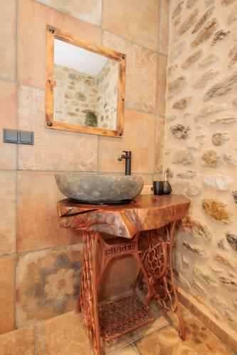 a bathroom with a sink on a wooden table at Mystras Panorama House in Mystras