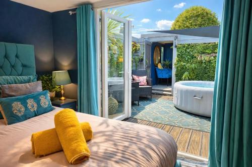 a bedroom with a large bed and a tub in a yard at A Hidden Gem With Private Hot Tub and Garden - Netflix - Fast Wifi - Free Parking in Bournemouth