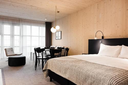a bedroom with a bed and a table and chairs at Reykjavik Residence Apartment Hotel in Reykjavík