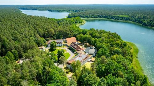 an aerial view of a house on the shore of a lake at Hotel Döllnsee-Schorfheide in Templin