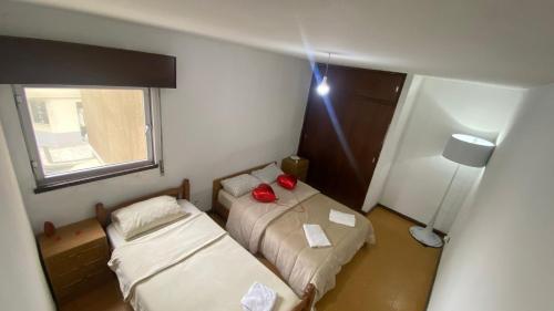 a small room with two beds and a lamp at Daboussi Home in Apúlia
