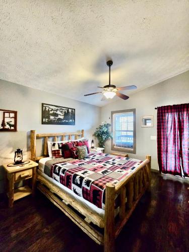 a bedroom with a wooden bed and a ceiling fan at Hidden Love in Gatlinburg
