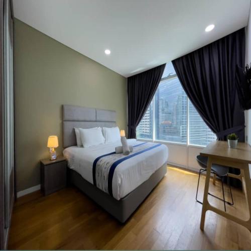 a bedroom with a bed and a large window at Vortex Apartment klcc by HouseFull in Kuala Lumpur