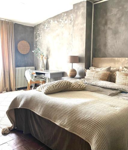 a bedroom with a large bed and a table at Dreamhome B&B Limoux in Limoux