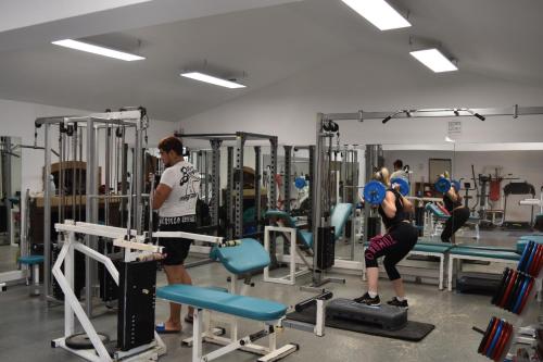 a group of people in a gym with weights at Camping Marina Plage in Vitrolles