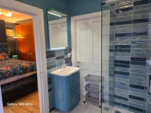 a bathroom with a sink and a shower at Great Central self-contained flat in Cambridge
