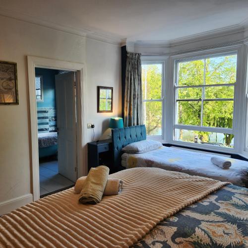 a bedroom with a large bed and a window at Great Central self-contained flat in Cambridge