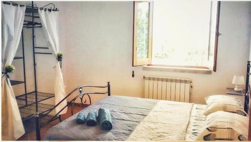 a bedroom with a bed with two pairs of shoes on it at Macari Villa Laura in Macari