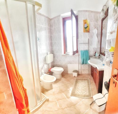 a bathroom with a shower and a toilet and a sink at Macari Villa Laura in Macari