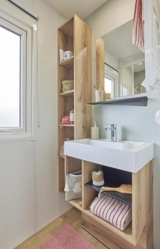 a bathroom with a sink and a mirror at Camping Bel Air - Cancale in Cancale