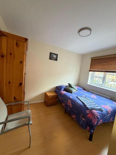 a bedroom with a bed and a chair in it at Beautiful Double Room in Heart of London in London