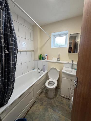 a bathroom with a tub and a toilet and a sink at Beautiful Double Room in Heart of London in London