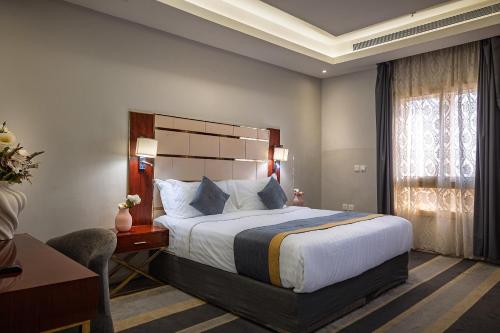 a hotel room with a bed and a desk at Rasis Serviced Apartments in Jeddah