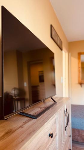 a large flat screen tv sitting on top of a dresser at Fabians Ferienhaus Rursee Rusti in Simmerath