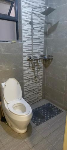 a bathroom with a toilet and a shower at Hillary homes in Nairobi