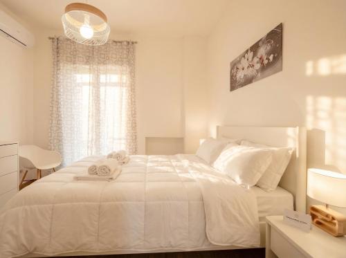 a bedroom with a white bed with a teddy bear on it at LARI - appartamento moderno in centro in Bari