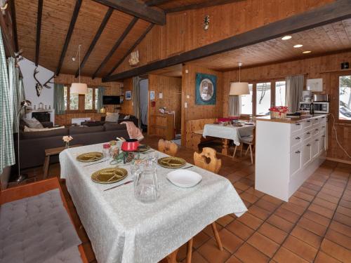 a kitchen and living room with a table in a room at Chalet Sven Heul by Interhome in Nendaz