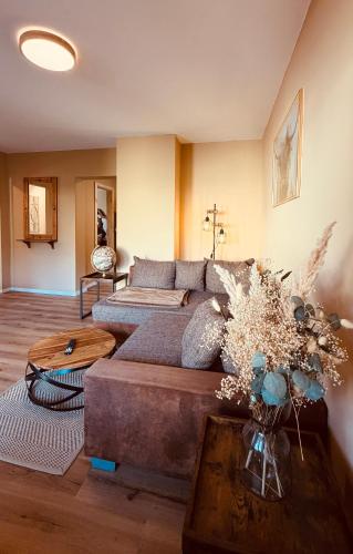 a living room with a couch and a table at Fabians Ferienhaus Rursee Rusti in Simmerath