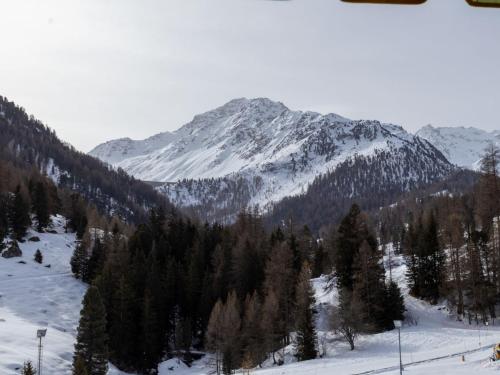 a snow covered mountain with trees in the foreground at Apartment Rosablanche D31 by Interhome in Siviez