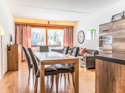 a kitchen and living room with a table and chairs at Apartment Rosablanche D31 by Interhome in Siviez