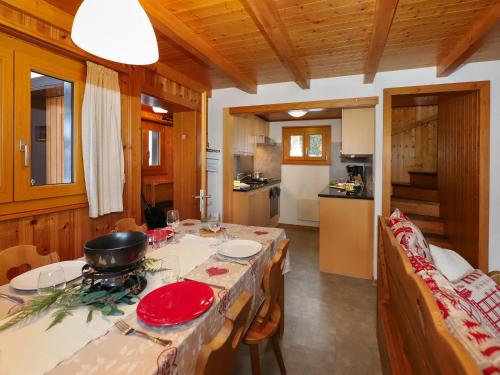 a kitchen with a table with a red plate on it at Chalet Coucordin by Interhome in Nendaz