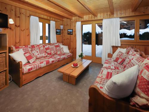 a living room with two couches and a table at Chalet Coucordin by Interhome in Nendaz